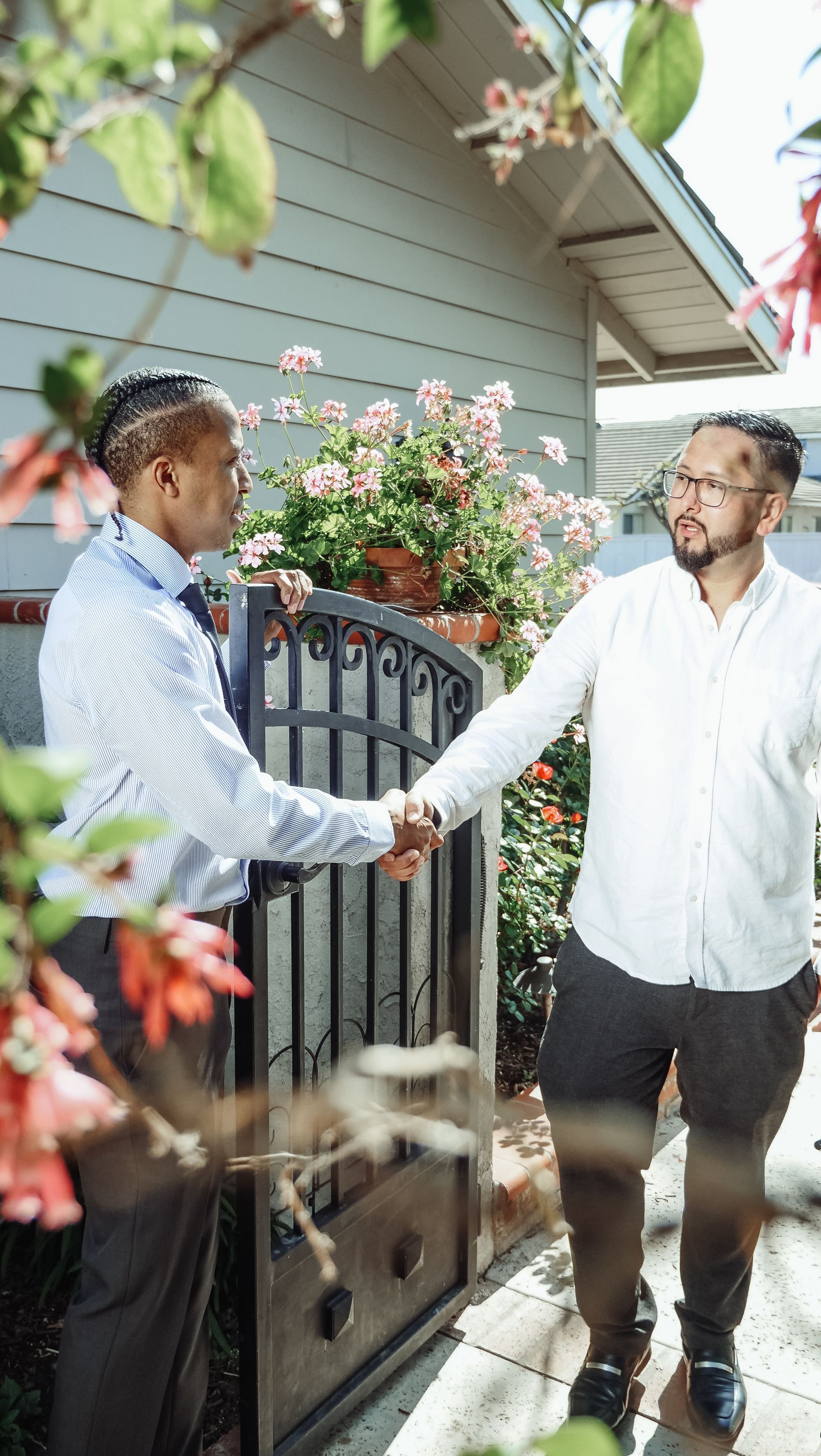 Shaking hands with a homeowner outside their house
